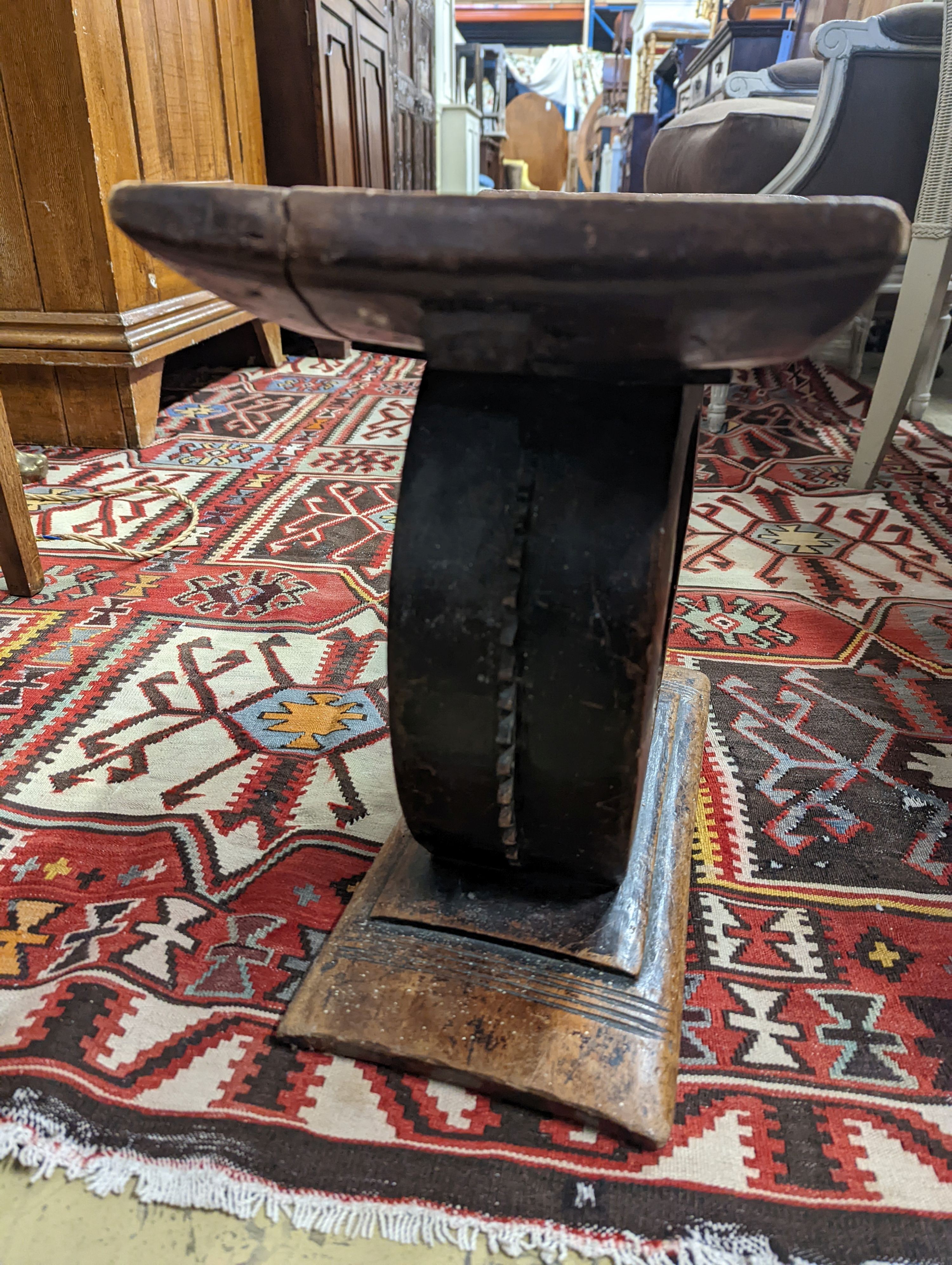 Two African carved hardwood stools, larger length 43cm, depth 19cm, height 37cm